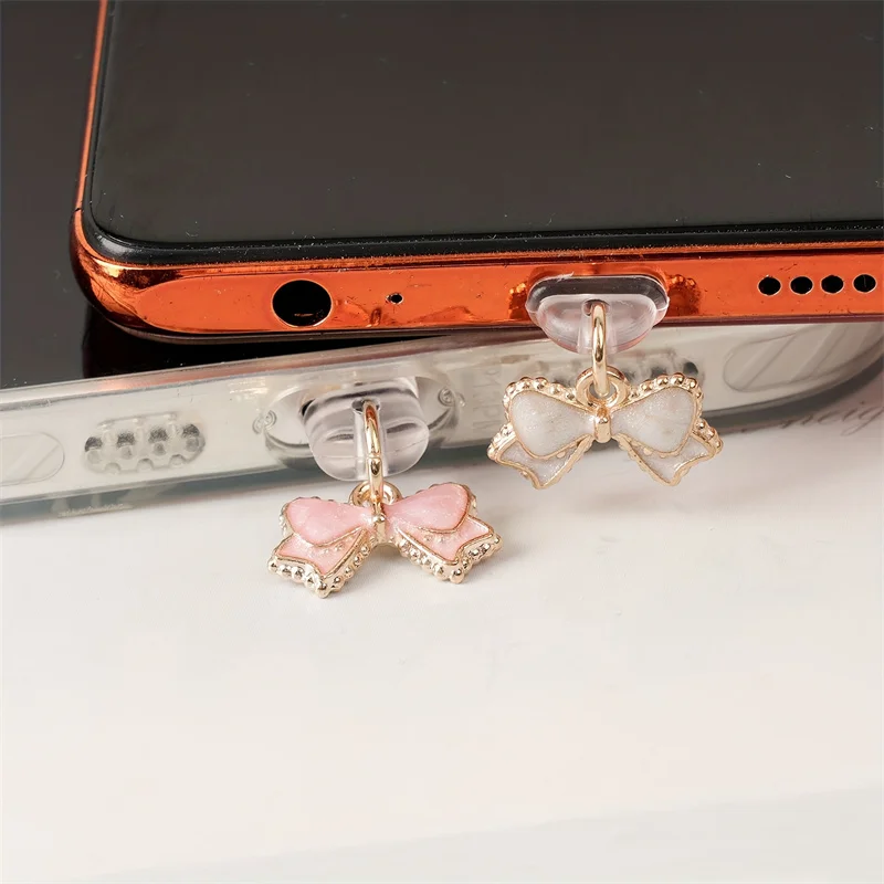 จุกปิดกันฝุ่นรูปโบว์สีชมพูขาวส - Mobile Tech Accessories บทวิจารณ์และราคา